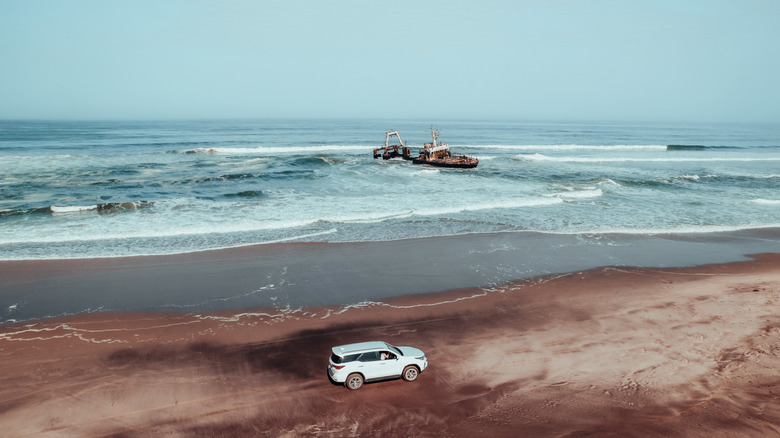 Car on beach near Zeila shipwreck on the Skeleton Coast in Africa