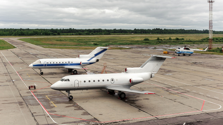 A small airport with two small airplanes on the runway
