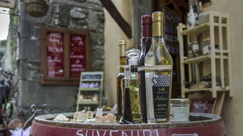Bottles of Croatian liqueur on top of a wooden barrel in Hum, Croatia
