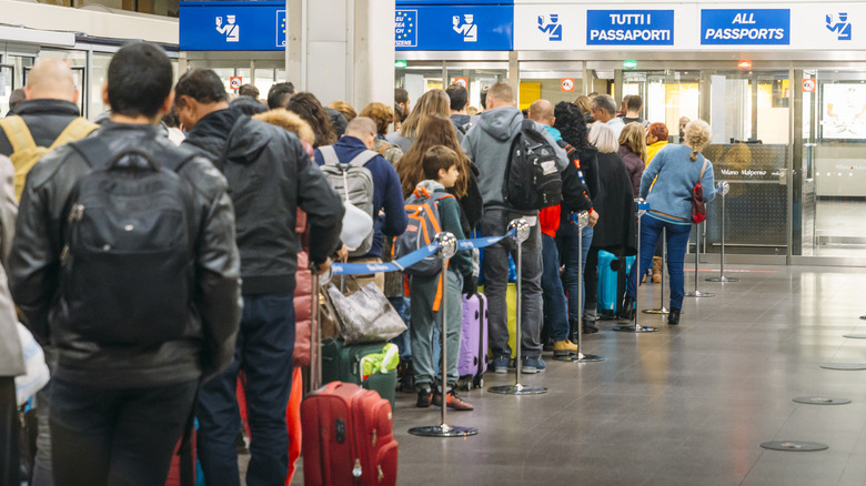 People waiting to go through immigration in Italy