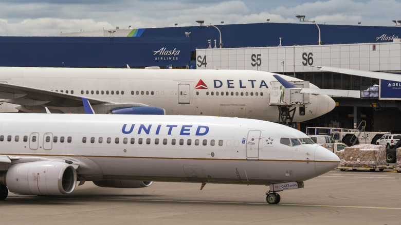 United and Delta Airlines airplanes side by side on the ground.