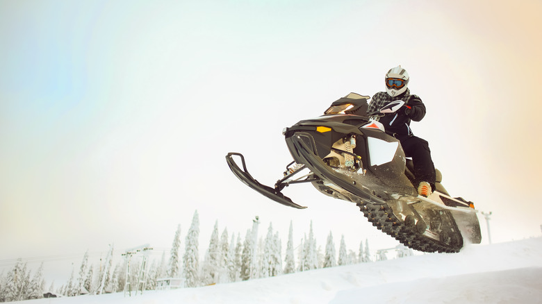 A snowmobiler gets air in the Wisconsin Northwoods