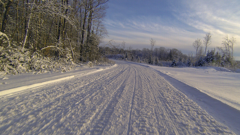 A snowmobiling trail in Vermont on a sunny day