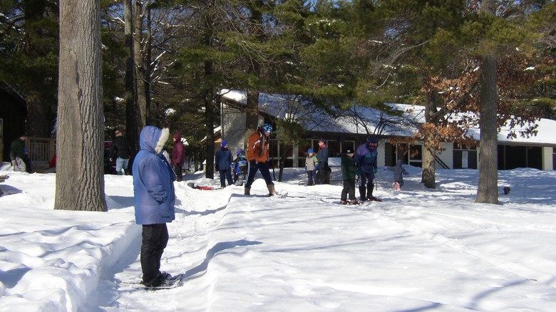 Adults and kids snowshoeing at Moreau Lake State Park