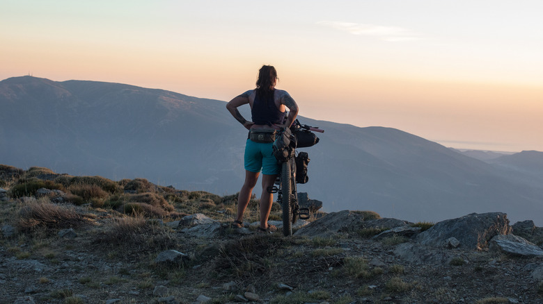 A bikepacker overlooking a scenic vista in Spain