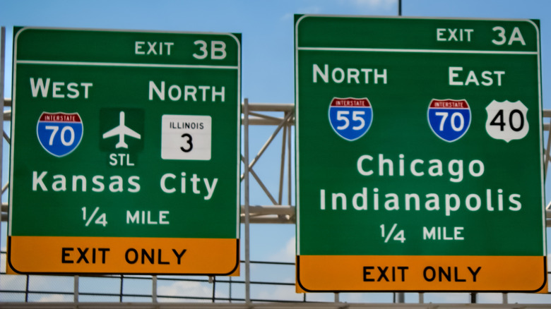Large exits signs on the highway