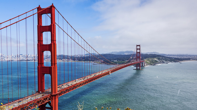 Cars driving across the Golden Gate Bridge on a sunny day