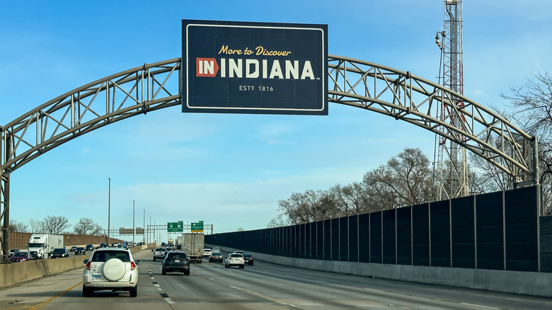 A "welcome to Indiana" sign on the highway driving from Lansing, Illinois