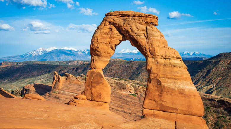 Delicate Arch frames mountains in Arches National Park
