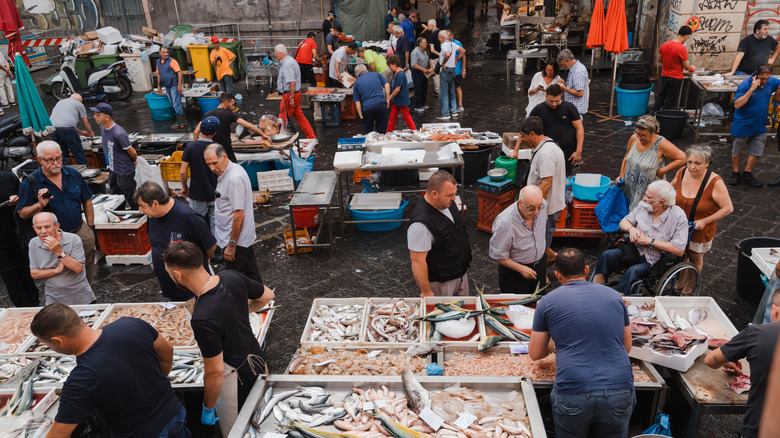 People at a fish market in Catania, Sicily