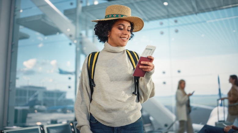 A woman reading her boarding pass