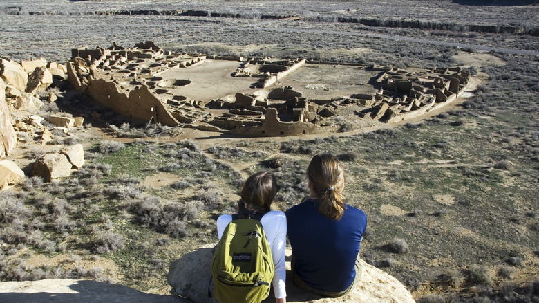 Two hikers look down on Chaco Culture National Historical Park