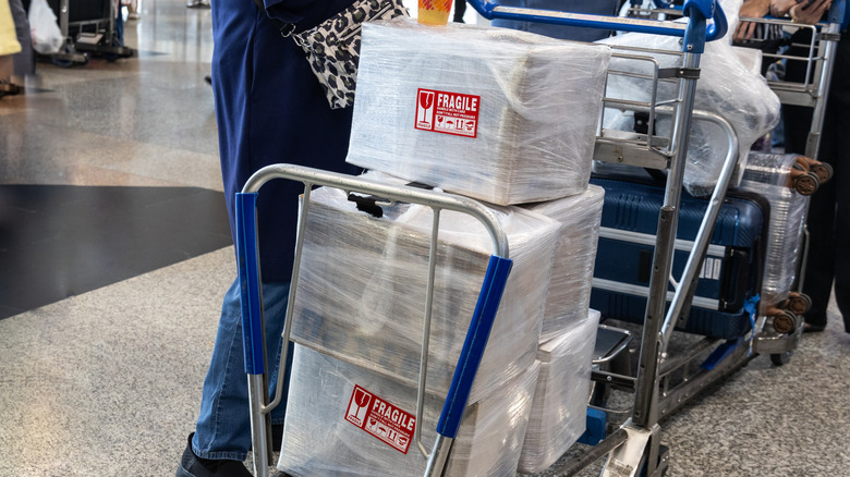 Luggage marked as fragile on its way onto the plane