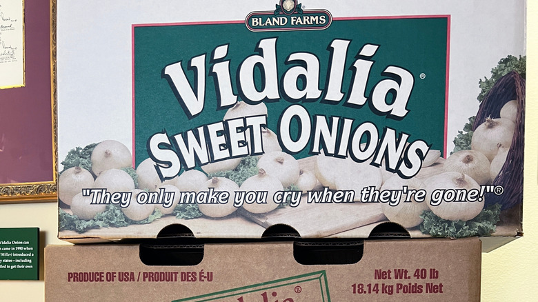 A cardboard vegetable box from Bland farms that reads Vidalia Sweet Onions they only make you cry when they're gone.