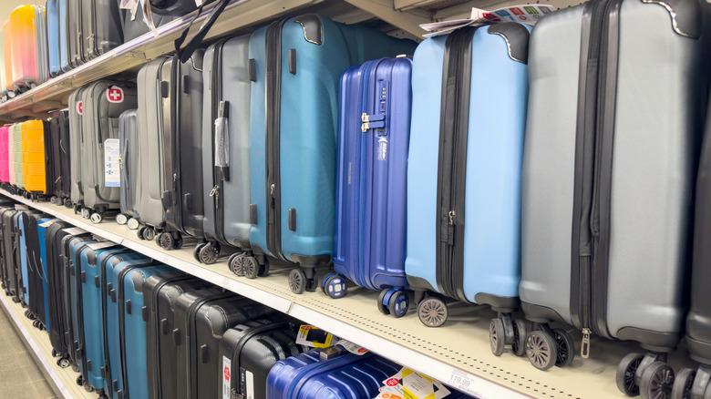 Rows of luggage on store shelves