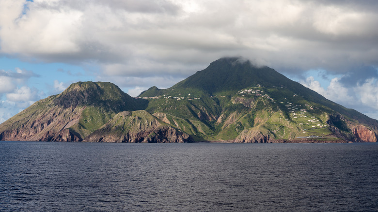 The profile of Saba's mountains rise from a steely Caribbean Sea as viewed distantly from the water