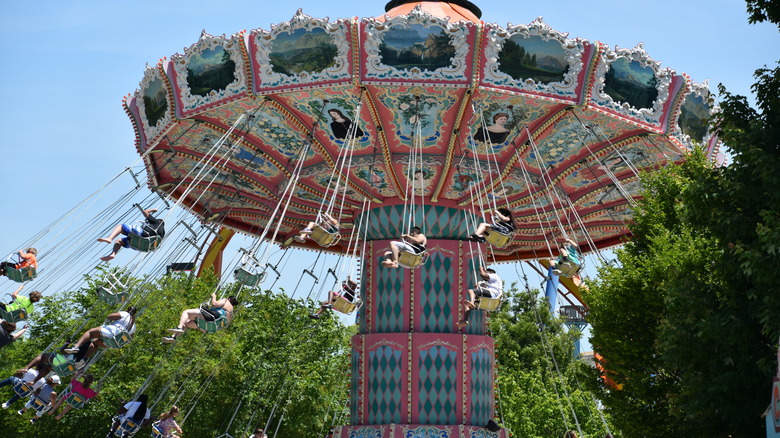 Attendees at Dorney Park in Allentown, Pennsylvania, on a large red and blue swing ride