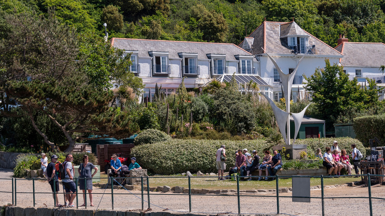 The White House Hotel and Ship Inn restaurant on Herm island with people sitting