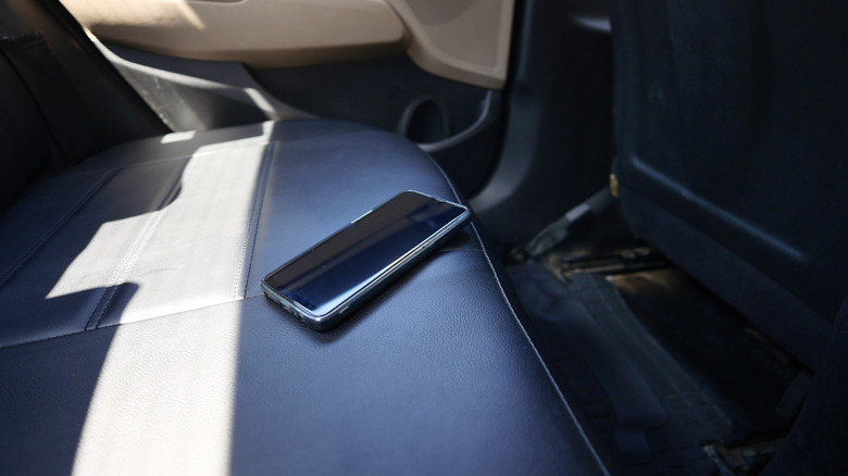 A smartphone left on the back seat of a car