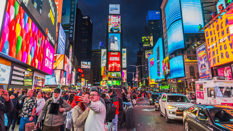 New York City's Times Square at night with traffic and street life