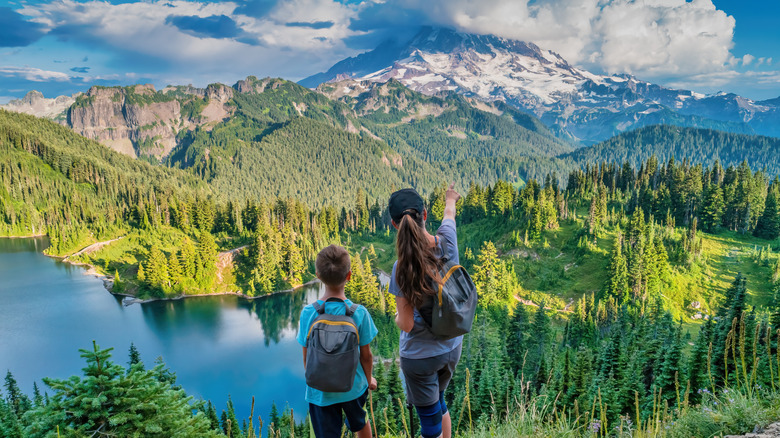 Woman and child at viewpoint overlooking water in Mount Rainier National Park