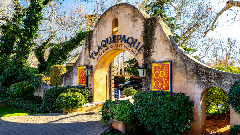 Entranceway to Tlaquepaque Arts and Crafts Village with arched doorway and greenery