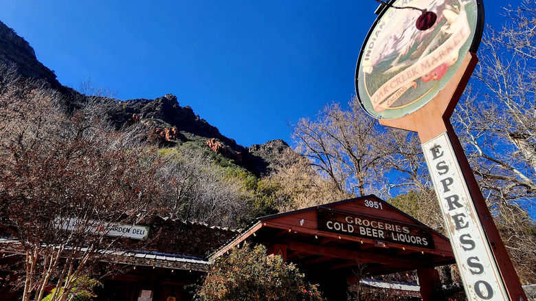 Exterior sign and mountains behind Indian Gardens Cafe