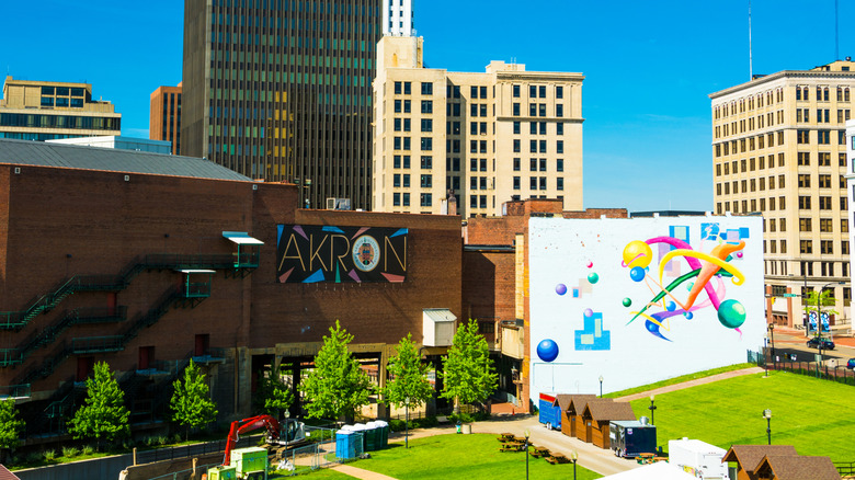 Downtown Akron, with the skyline in the background and a brick building and a colorful mural