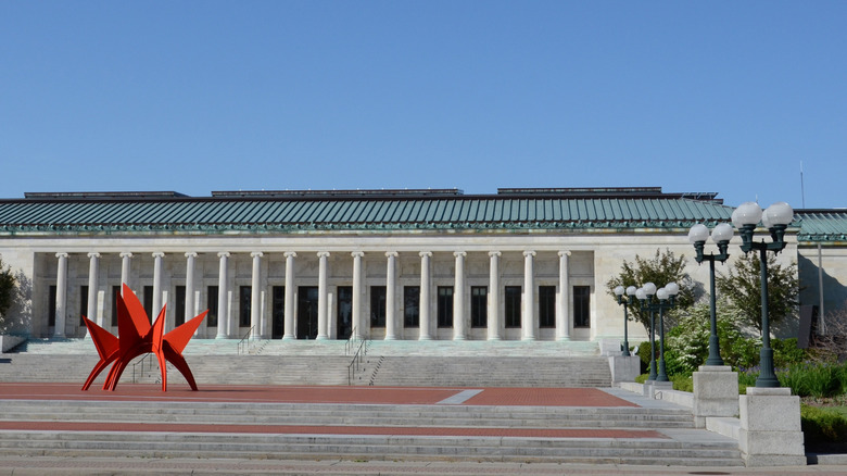 Toledo Museum of Art with a red sculpture out front on a sunny day