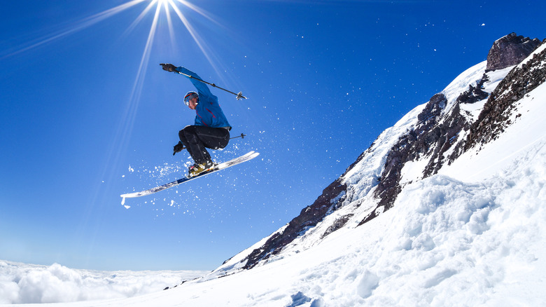 A person skiing on a mountain on a sunny day