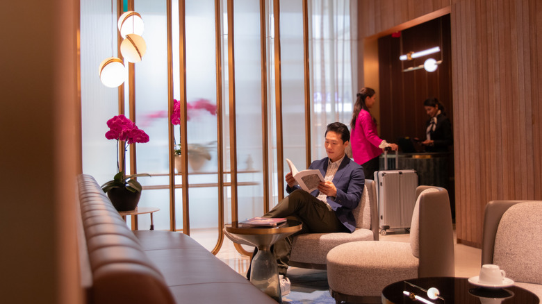 A traveler relaxing inside a VIP airport lounge