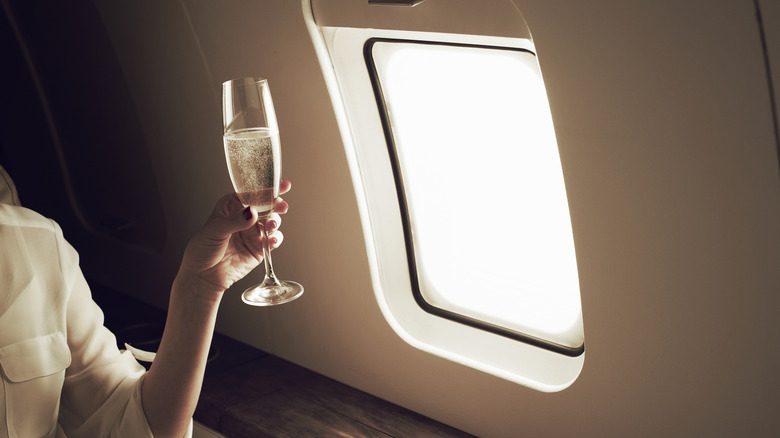 Passenger toasting in private jet
