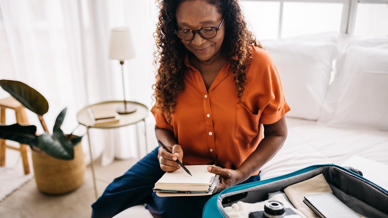 Woman organizing while she packs