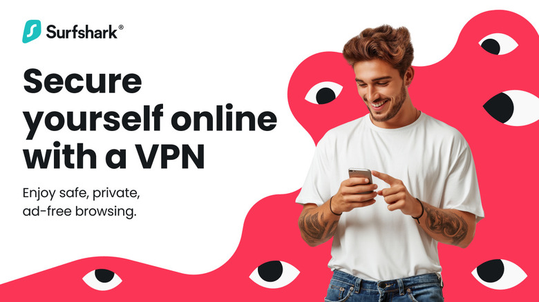 Man wearing a white t-shirt and jeans flashes a big smile as he looks at this phone.
