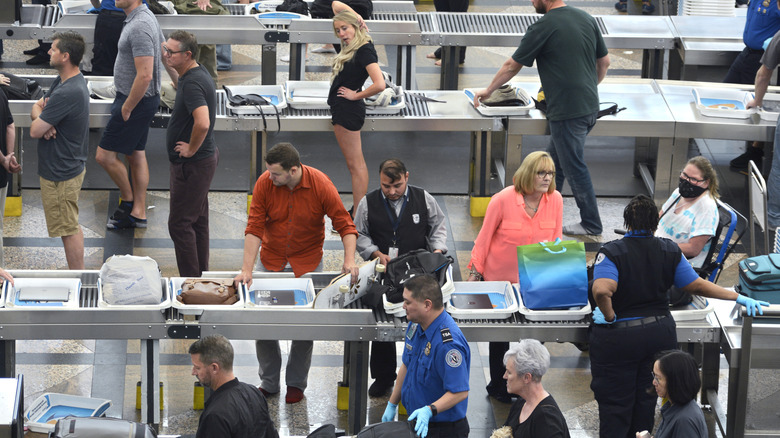 Passengers waiting in line at airport TSA checkpoint