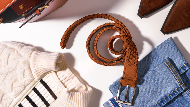 Belt with a buckle and other clothes laid out