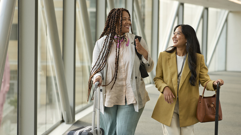 Women wearing coats in the airport