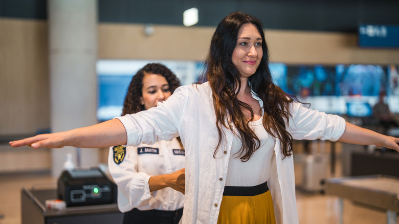 Woman being patted down at airport security