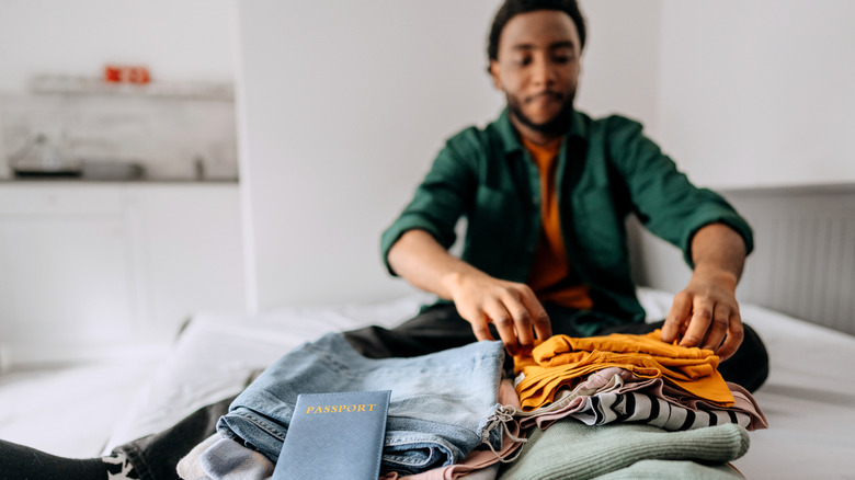 Man packing clothes into a suitcase