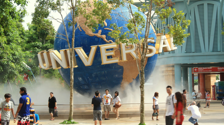 People gathering around the Universal Studios globe at the Singapore theme park