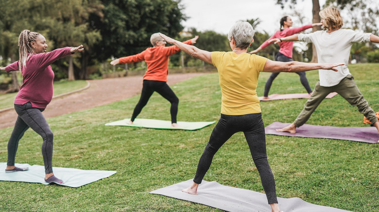 Senior women doing yoga in a UK park
