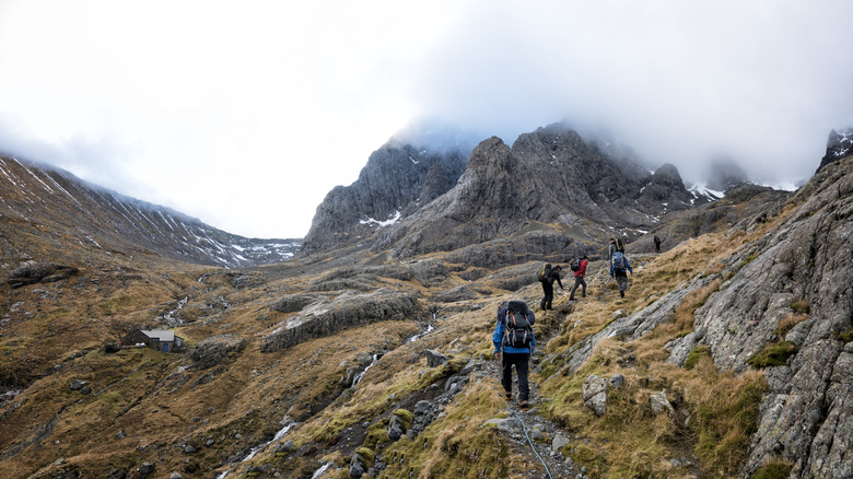Hikers make their way along one of the steep paths up craggy Ben Nevis