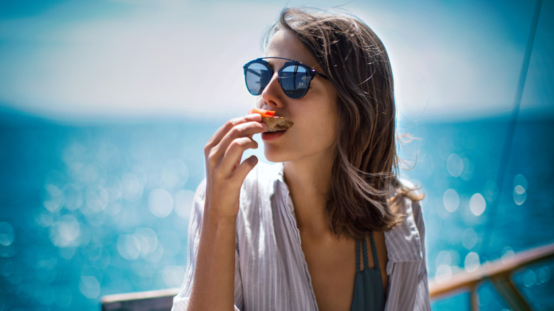 Woman eating a snack on a cruise