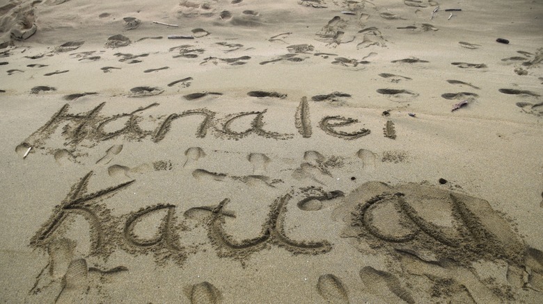 'Kauai' written in the sand at hanalei Beach.