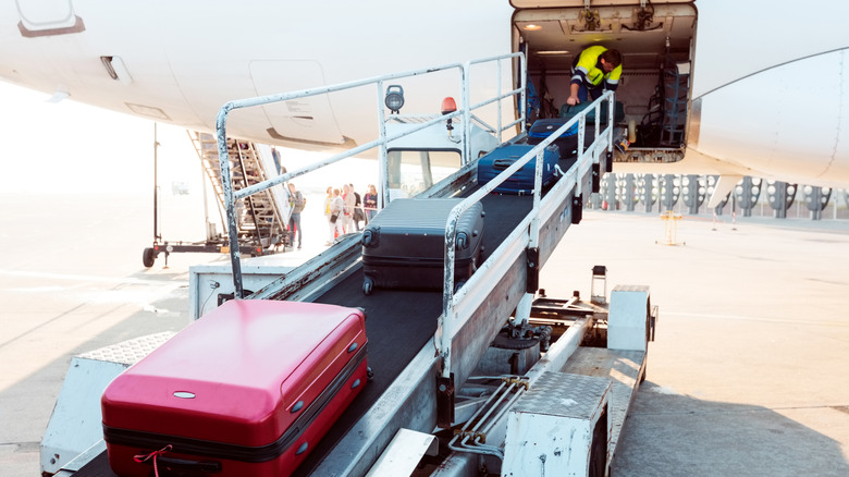 Ground crew loading luggage