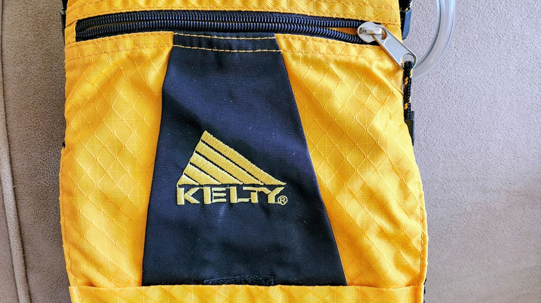 The Kelty logo adorns a bright yellow bag
