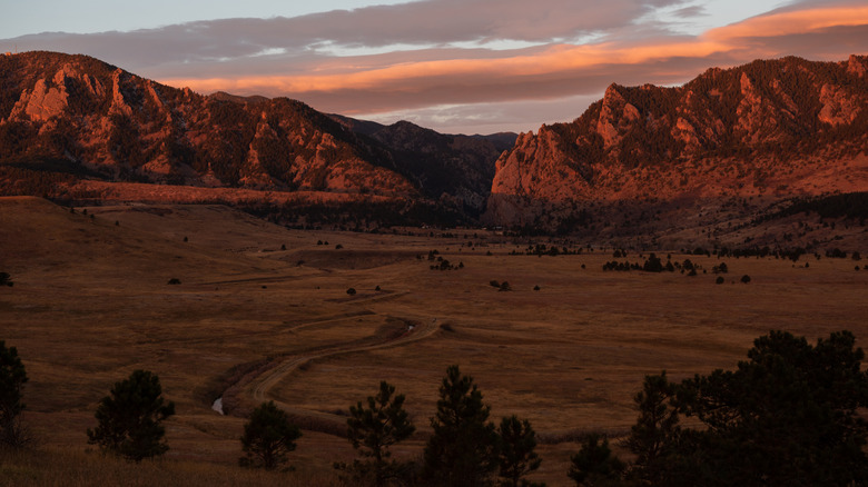 A road leads towards the rocky entrance to Eldorado Canyon in Colorado
