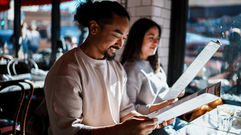 Smiling tourists at Little Italy restaurant in San Francisco