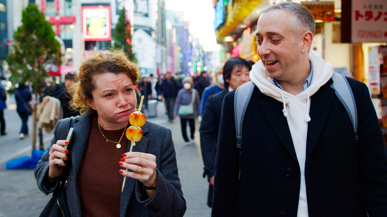 tourists eating tokyo street food