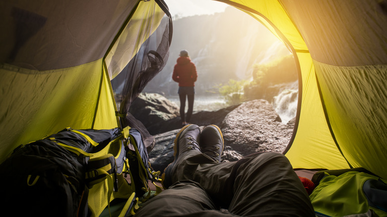 person lounging in open tent